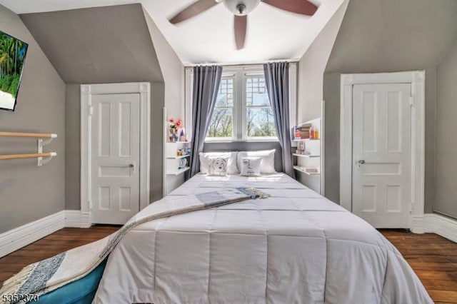 bedroom featuring a ceiling fan, baseboards, vaulted ceiling, and wood finished floors