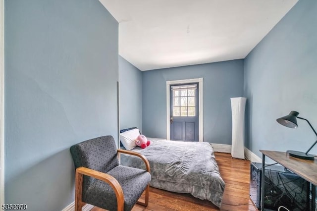 bedroom with baseboards and wood finished floors
