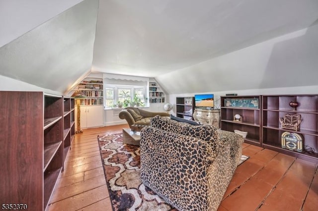 living area with lofted ceiling and hardwood / wood-style floors