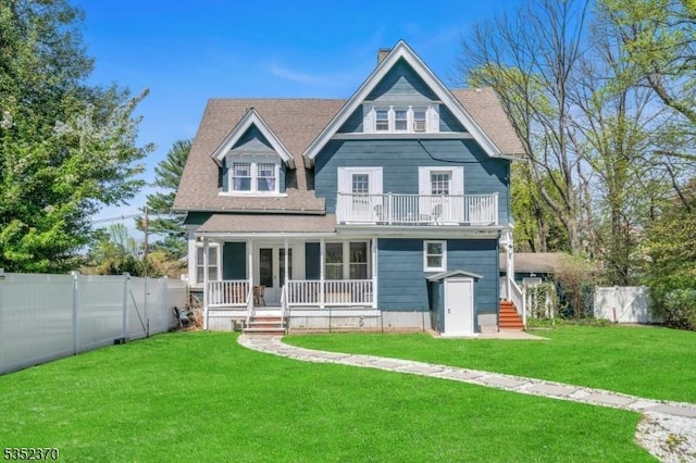 view of front of home featuring fence private yard, a porch, a front lawn, and a balcony