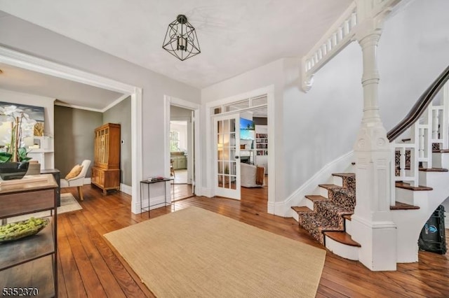entrance foyer featuring stairway, baseboards, and hardwood / wood-style floors