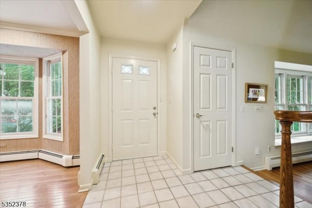 entryway featuring baseboard heating, baseboards, and plenty of natural light