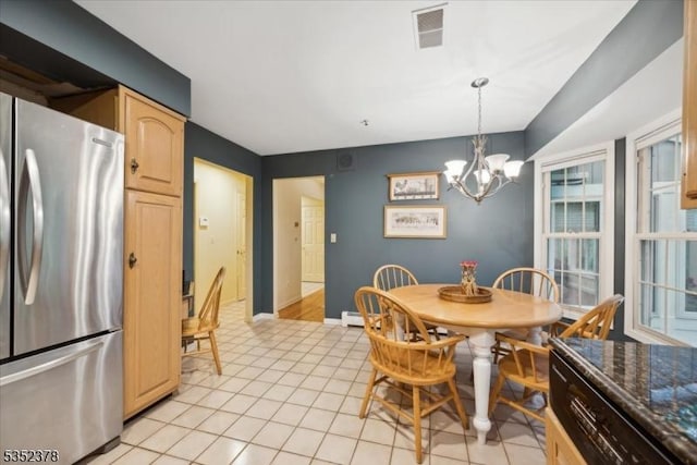 dining room with a chandelier and baseboards