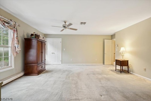 empty room featuring a baseboard radiator, ceiling fan, light carpet, and baseboards