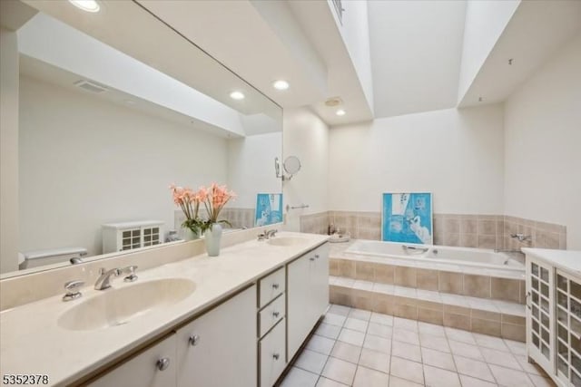 full bathroom with a bath, tile patterned floors, recessed lighting, double vanity, and toilet
