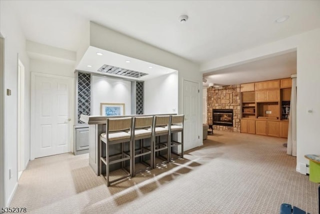 bar featuring carpet flooring, a fireplace, and recessed lighting