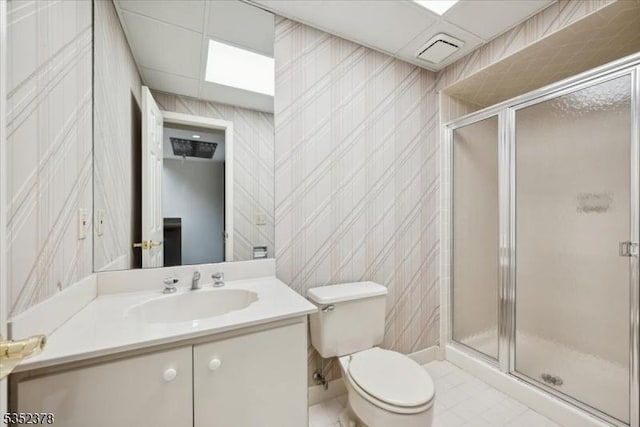 full bath with a shower stall, toilet, vanity, and tile patterned floors