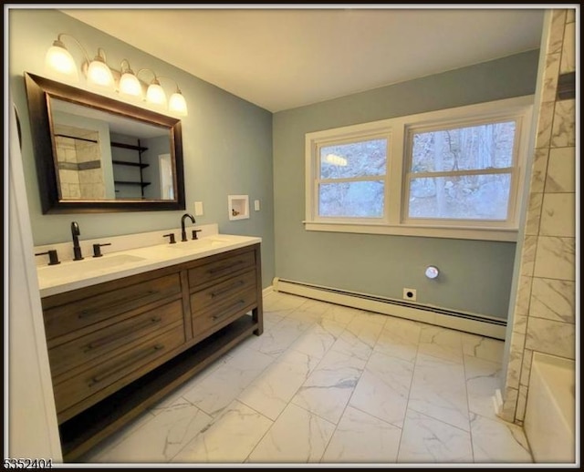 bathroom featuring a sink, a baseboard heating unit, double vanity, and marble finish floor