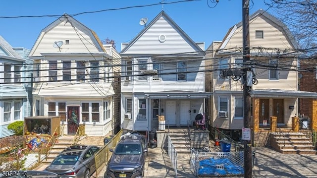 townhome / multi-family property with a gambrel roof