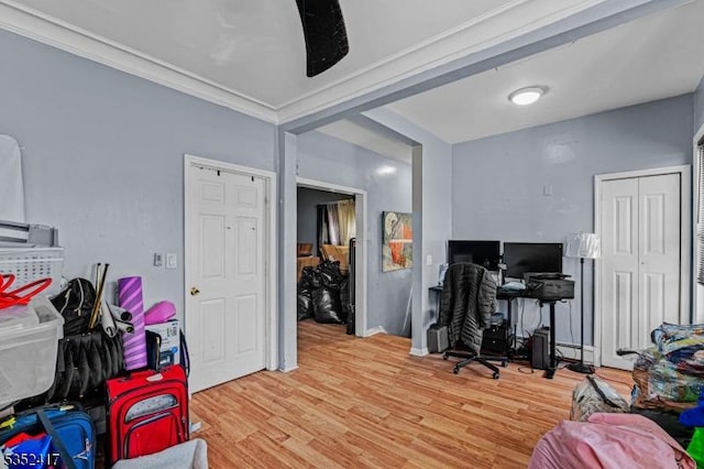 office space with wood finished floors and crown molding
