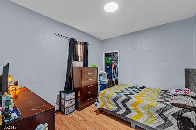 bedroom with a closet and light wood finished floors