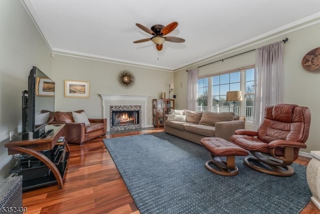 living room featuring wood finished floors, a ceiling fan, and ornamental molding