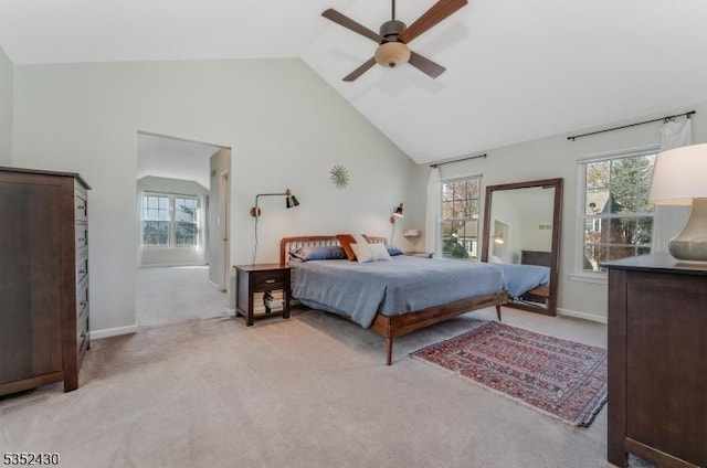 bedroom featuring high vaulted ceiling, light colored carpet, and multiple windows