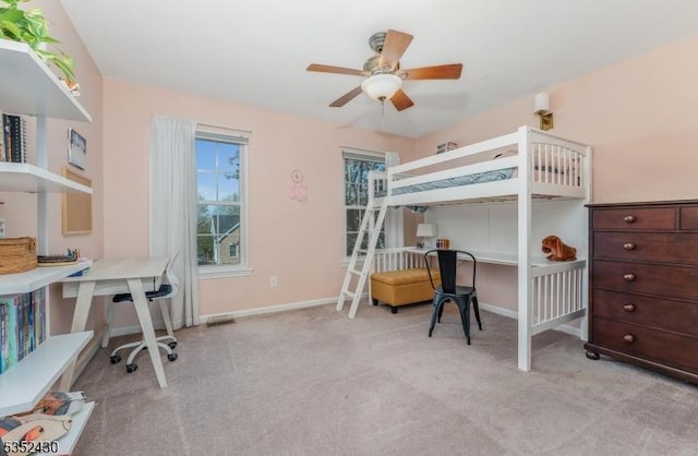 bedroom with ceiling fan, light carpet, and baseboards