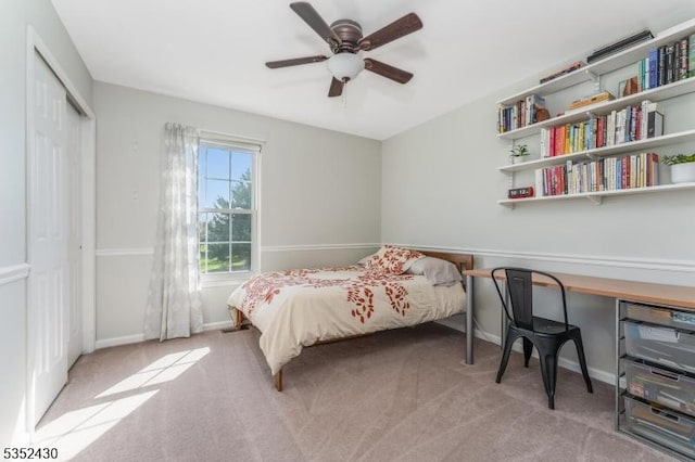 bedroom with baseboards, carpet, a closet, and ceiling fan