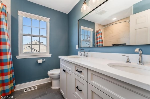 bathroom featuring plenty of natural light, a sink, and tile patterned floors