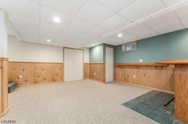 finished basement featuring carpet floors and wainscoting