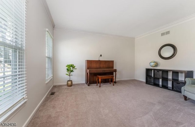 living area featuring baseboards, crown molding, carpet flooring, and visible vents