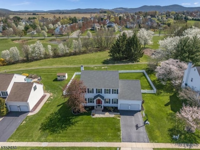 birds eye view of property featuring a mountain view and a residential view