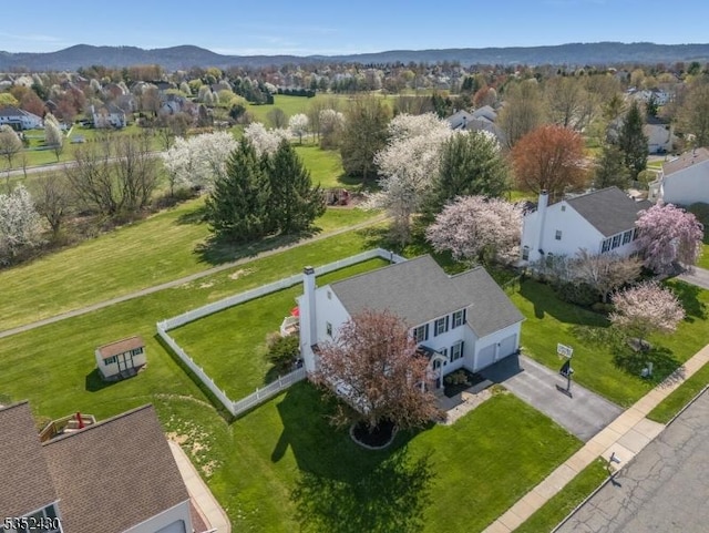 birds eye view of property with a mountain view and a residential view