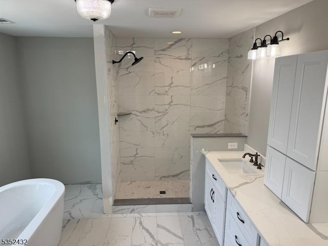 bathroom with visible vents, a freestanding bath, vanity, marble finish floor, and a marble finish shower