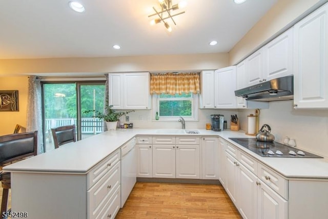 8 Kevin Dr, Mount Olive Twp, NJ 07836 - kitchen with under cabinet range hood, a peninsula, electric stovetop, light countertops, and recessed lighting