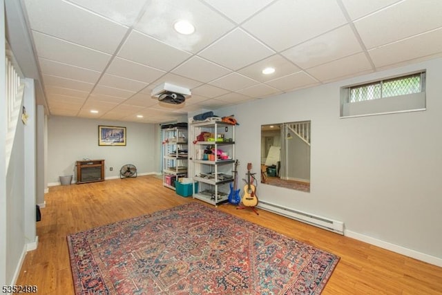 8 Kevin Dr, Mount Olive Twp, NJ 07836 - rec room featuring a baseboard heating unit, wood finished floors, recessed lighting, baseboards, and a drop ceiling