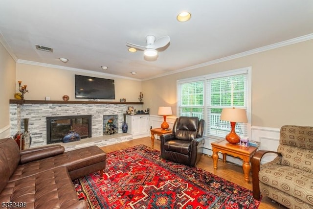 8 Kevin Dr, Mount Olive Twp, NJ 07836 - living room with crown molding, wood finished floors, a glass covered fireplace, a wainscoted wall, and a ceiling fan