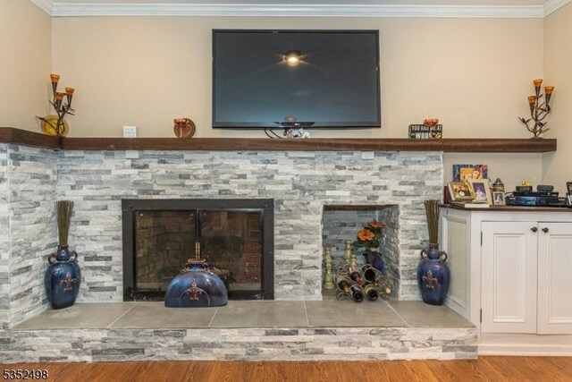 8 Kevin Dr, Mount Olive Twp, NJ 07836 - detailed view of a fireplace with raised hearth, ornamental molding, and wood finished floors