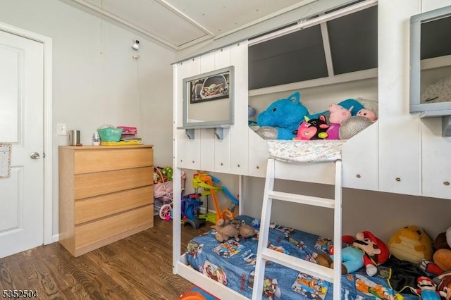 bedroom with attic access and dark wood-type flooring