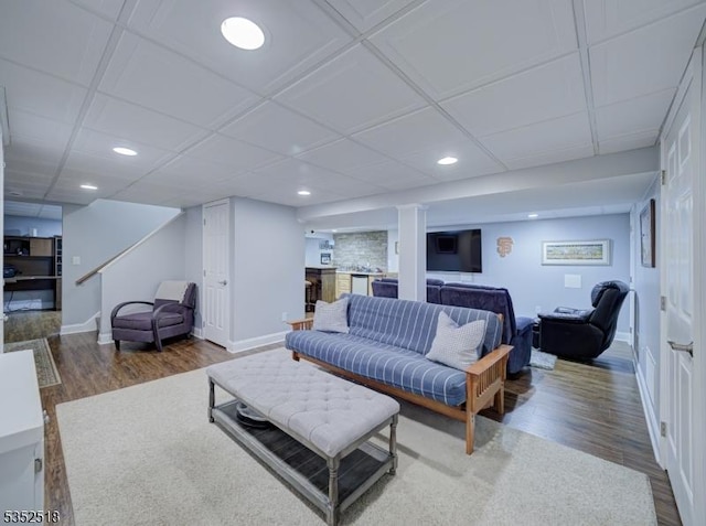 living room featuring stairs, wood finished floors, recessed lighting, and baseboards