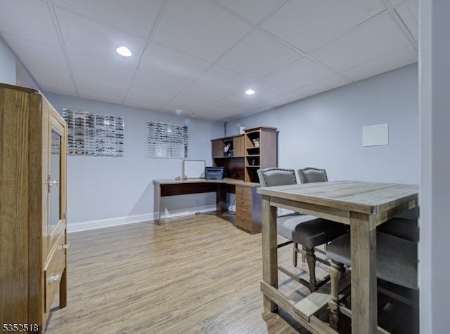 home office with recessed lighting, wood finished floors, baseboards, and a drop ceiling