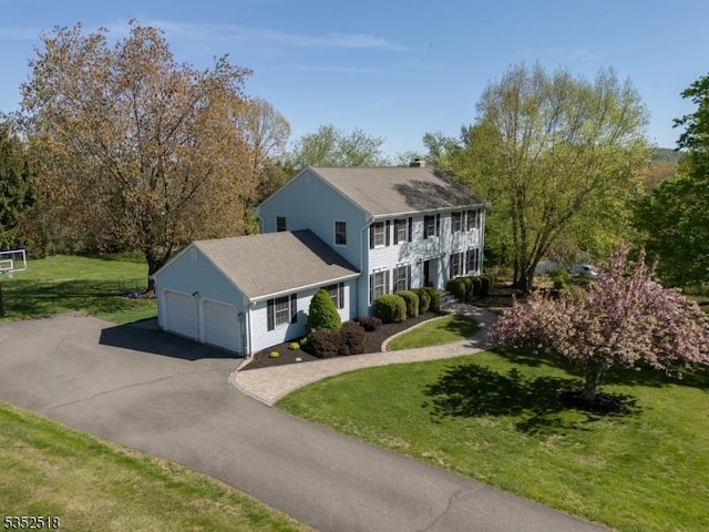 view of front of property with a front yard, driveway, and an attached garage