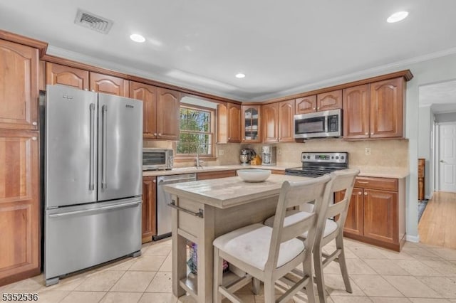 kitchen featuring visible vents, light countertops, light tile patterned floors, and stainless steel appliances
