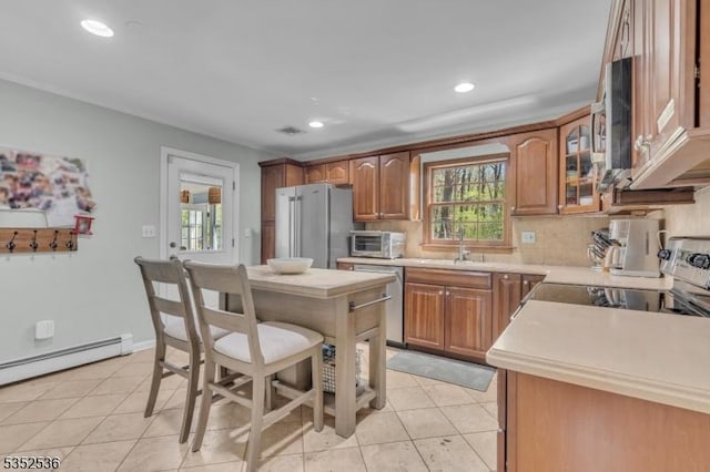 kitchen with light countertops, backsplash, stainless steel appliances, and visible vents