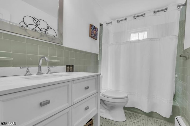 bathroom with tile walls, tile patterned flooring, shower / tub combo, a baseboard radiator, and toilet
