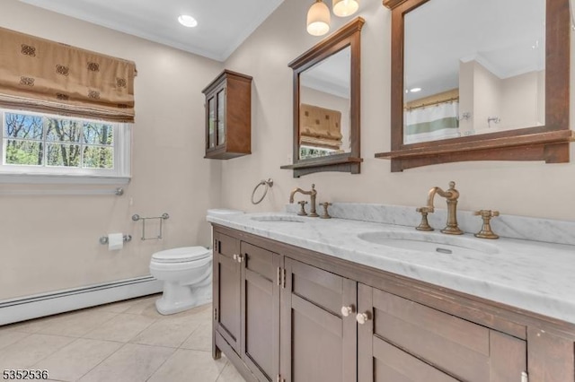 bathroom featuring toilet, tile patterned floors, a sink, and a baseboard radiator