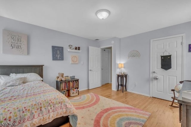 bedroom featuring baseboards and wood finished floors