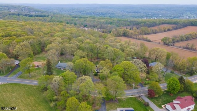 birds eye view of property with a wooded view