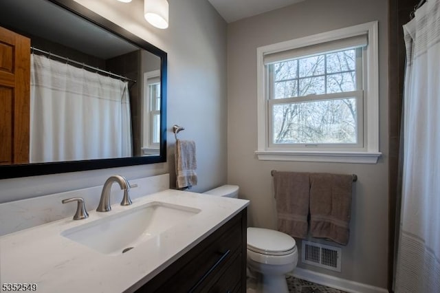 full bathroom featuring visible vents, vanity, and toilet