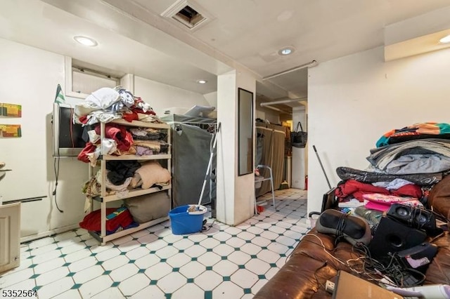 below grade area with tile patterned floors and recessed lighting
