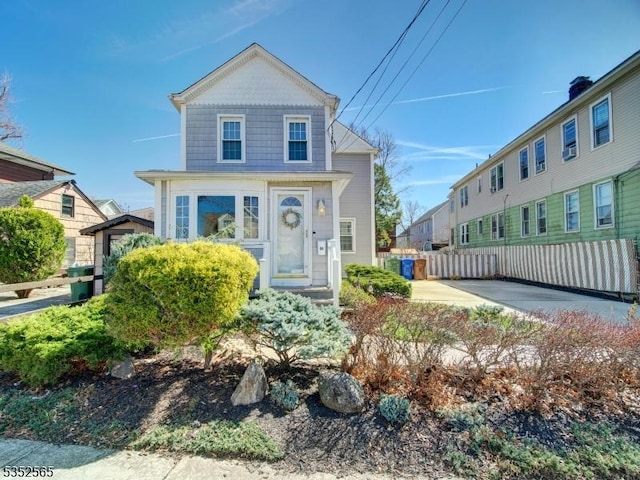 shotgun-style home with fence