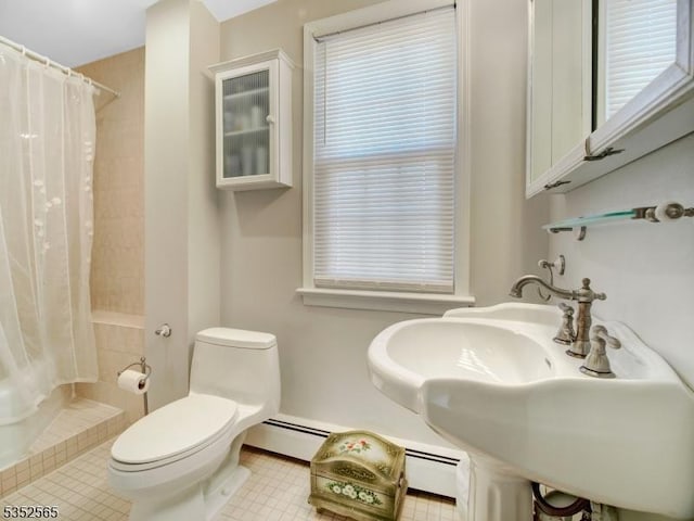 bathroom featuring baseboard heating, tiled shower, and toilet