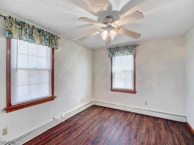 spare room featuring baseboards, wood finished floors, a ceiling fan, and a baseboard radiator