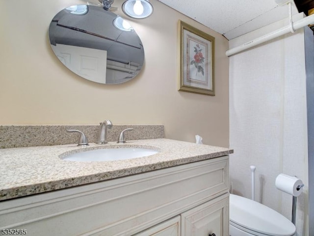 bathroom featuring toilet and vanity