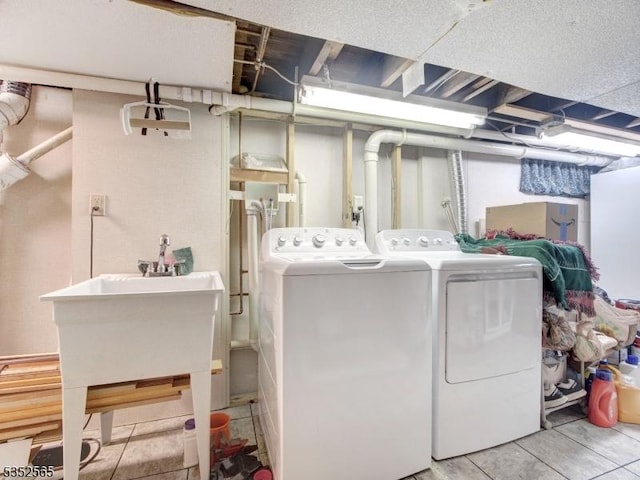 washroom featuring washing machine and dryer and laundry area