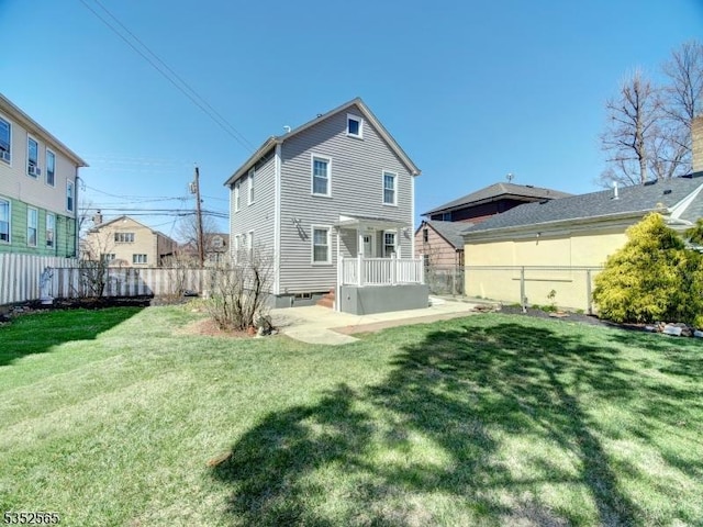 rear view of house with a yard and fence