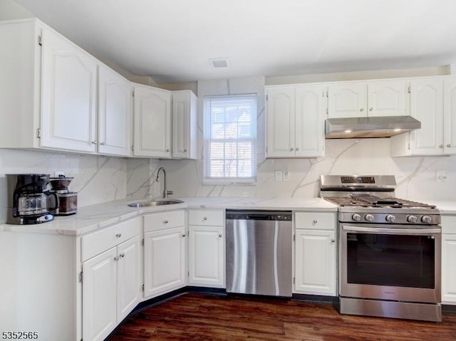 kitchen featuring white cabinetry, stainless steel appliances, under cabinet range hood, and a sink
