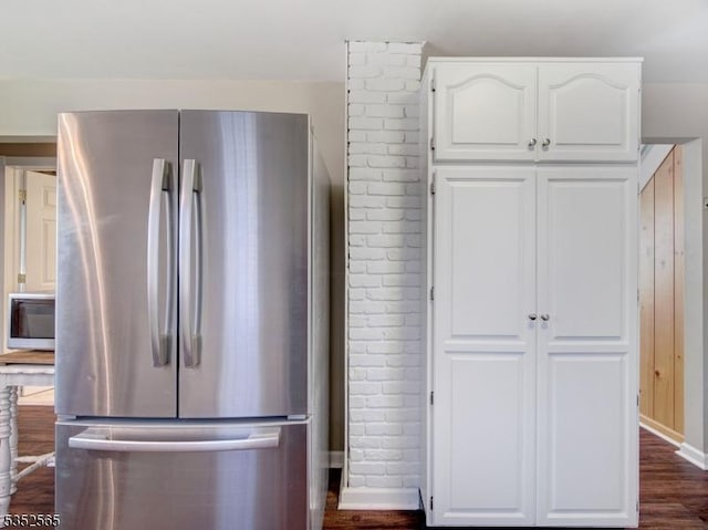 kitchen featuring baseboards, white cabinetry, stainless steel appliances, and dark wood-type flooring