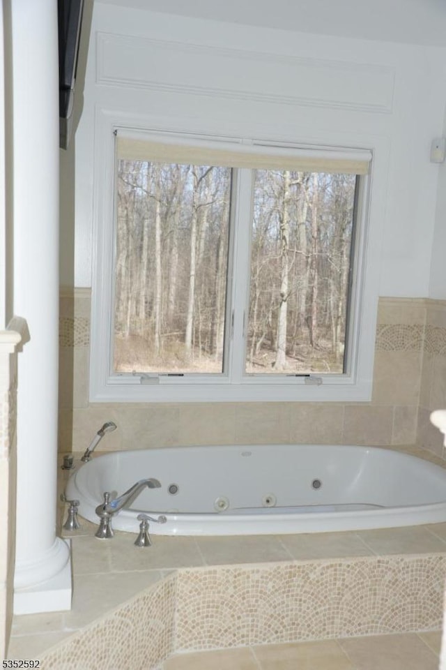 bathroom featuring a tub with jets